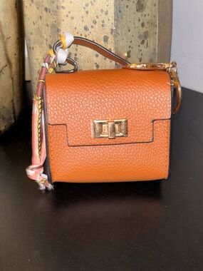 Charm- Woman’s  Orange Leather Mini Bag with Gold Hardware. Store Earpods.